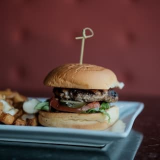 A gourmet cheeseburger on a plate